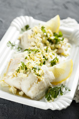 Carp fish with egg yolk sauce and herbs