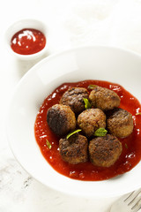 Meatballs with ketchup with tomatoes, chili and peaches