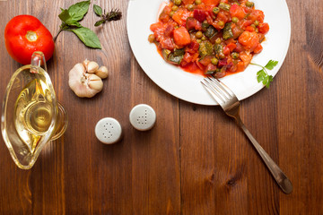 Fresh vegetable stew on wooden background
