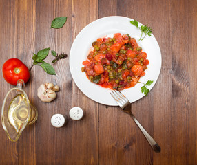 Fresh vegetable stew on wooden background