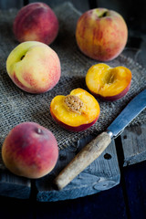 Peaches and apricot on the wood background. Rustic style. Summer and autumn fruits