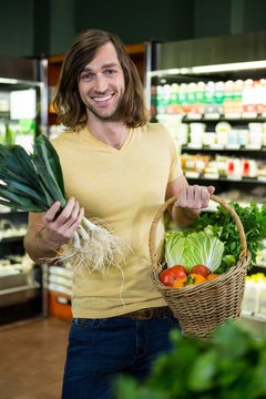 Man holding basket of vegetables