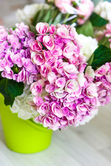 flowers in green bucket at workshop