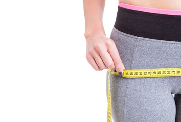 Close-up of woman measuring with tape line