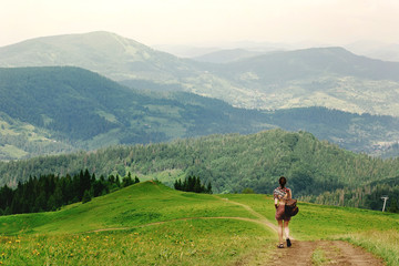 stylish hipster traveler walking at amazing mountains, summer tr