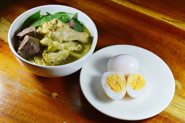 spicy chicken leg in green curry and boiled egg