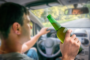 Unfocused man with alcohol in car