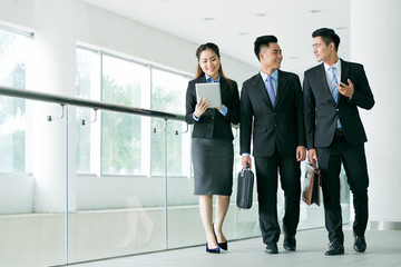 Young business colleagues talking on the way to work