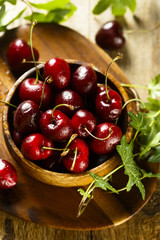 Fresh cherries in wooden bowl