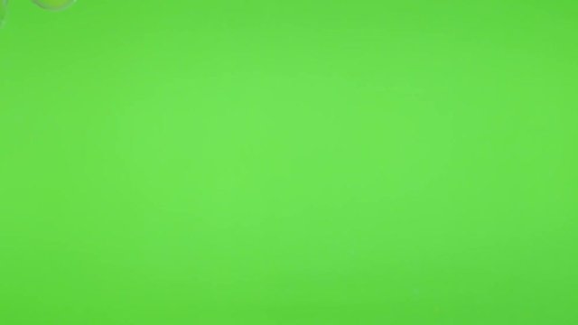 Green screen with soap bubbles flying and falling down 4K 2160p 30fps UltraHD video - Bubbles made of soap in front of greenscreen chroma key background 4K 3840X2160 UHD footage 