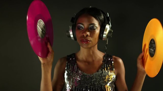 sexy young woman dancing with record vinyls