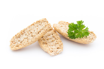 Dry flat bread crisps with herbs on a white background.