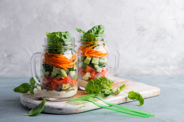 Healthy homemade mason jar salad with chicken and vegetables