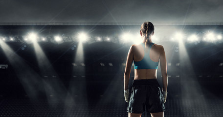 Obraz na płótnie Canvas Young boxer woman at ring . Mixed media