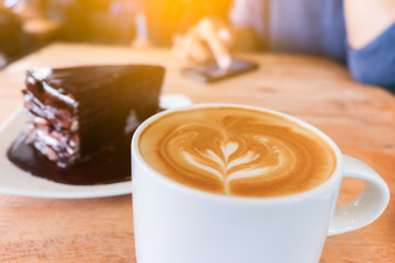 Coffee cup and chocolate cake on wood table  background woman us