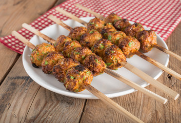 Thai curried fish cake grill on white plate.