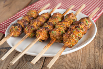 Thai curried fish cake grill on white plate.