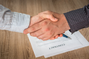 Business partners handshaking over successful conclusion