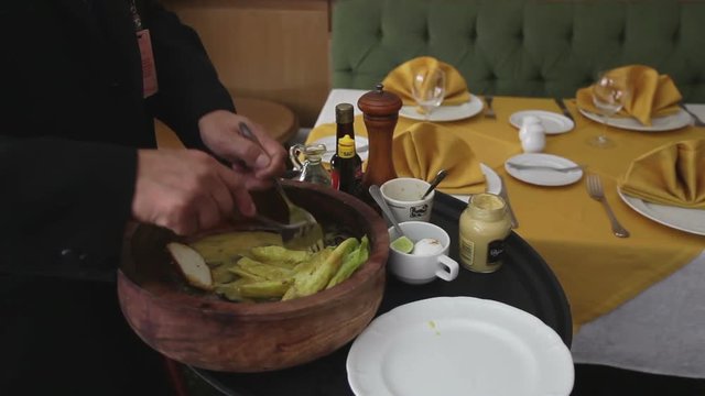 chef preparing a caesar salad in a restaurant