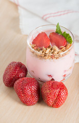 Healthy Strawberry yogurt with fresh strawberries and muesli.