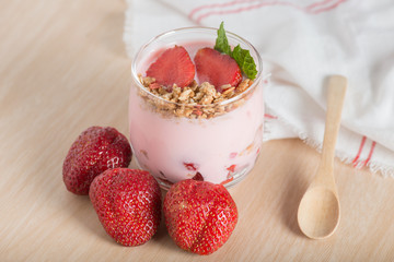 Healthy Strawberry yogurt with fresh strawberries and muesli.