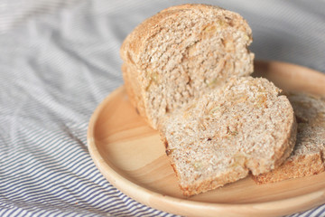 whole wheat bread is sliced on the wooden plate