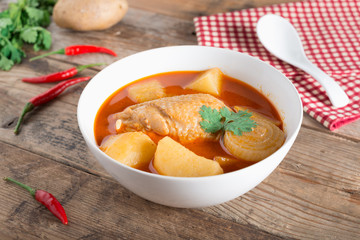 Chicken mussaman curry in bowl.