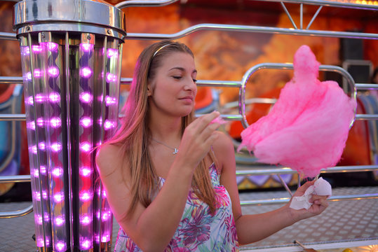 Young woman eating sweetened cotton candy