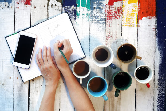 Business Time With Coffee On Colorful Wooden Panels Background.