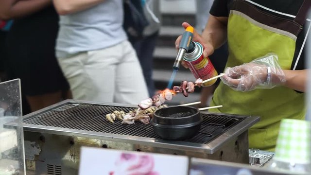 Local street food of Seoul, Korea, Octopus skewer steam and burn cooked before eating