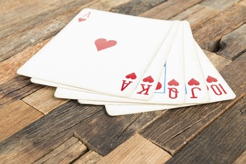 Poker cards, Royal flash on wooden background. Macro shot.