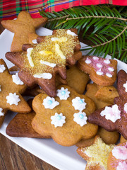Colorful Christmas gingerbread cookies on wooden background