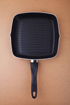 Grill pan on brown background