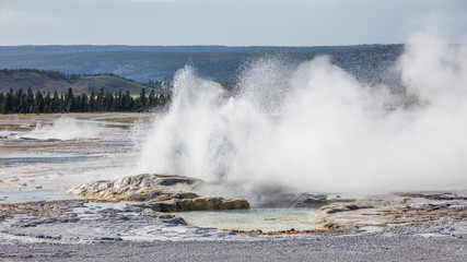 Erupting geyser with steam. Fountain Paint Pots. Yellowstone National Park, Wyoming