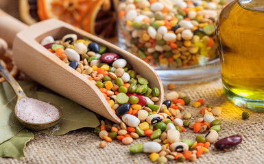 Wooden scoop and mixed raw legumes