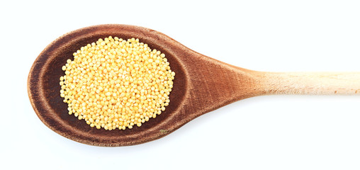 Millet in a wooden spoon