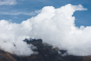 Mountain top in cumulus clouds