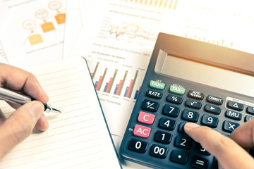 Close up of hand working with business documents. Photo with sunlight filter effect