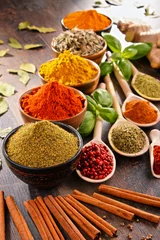 Fototapeten Variety of spices on kitchen table © monticellllo