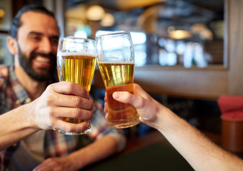 happy male friends drinking beer at bar or pub