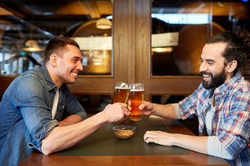 happy male friends drinking beer at bar or pub