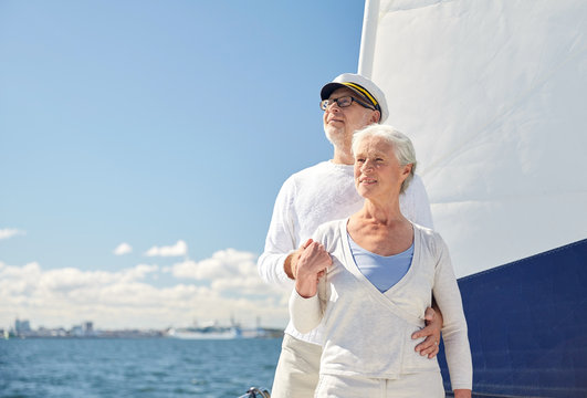 senior couple hugging on sail boat or yacht in sea