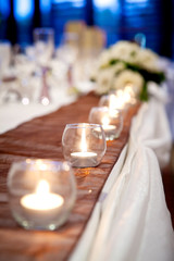Candle with Flowers on Bridal Table Wedding Theme