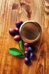 Fresh plum jam on a wooden background
