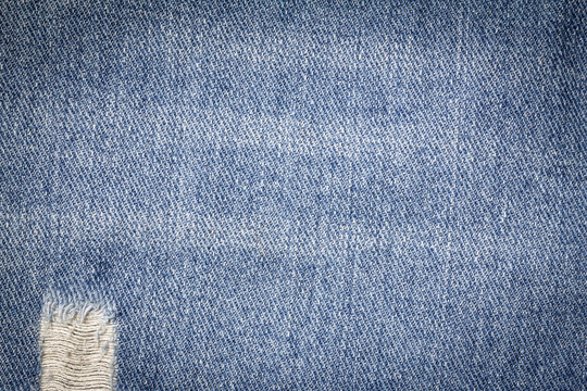 Denim jeans texture or denim jeans background with old torn. Old grunge vintage denim jeans. Stitched texture denim jeans background of fashion jeans design. Dark edged.