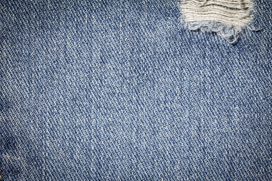 Denim jeans texture or denim jeans background with old torn. Old grunge vintage denim jeans. Stitched texture denim jeans background of fashion jeans design. Dark edged.