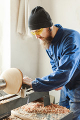 A man working with woodcarving instruments