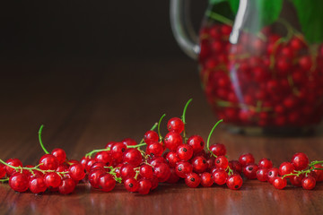 Close up with red currants berries with glass jug