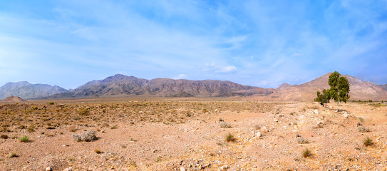 Panorama of mountains and plain with blue sky