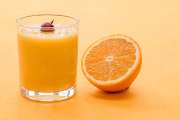 Orange smoothie with gooseberry on orange background